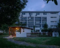North elevation of Anima Pavilion at twilight before a residential block, Atelier Pensee