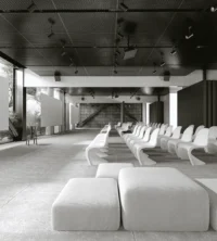 Corporativo MGP lobby lounge with rows of chairs under perforated metal ceiling