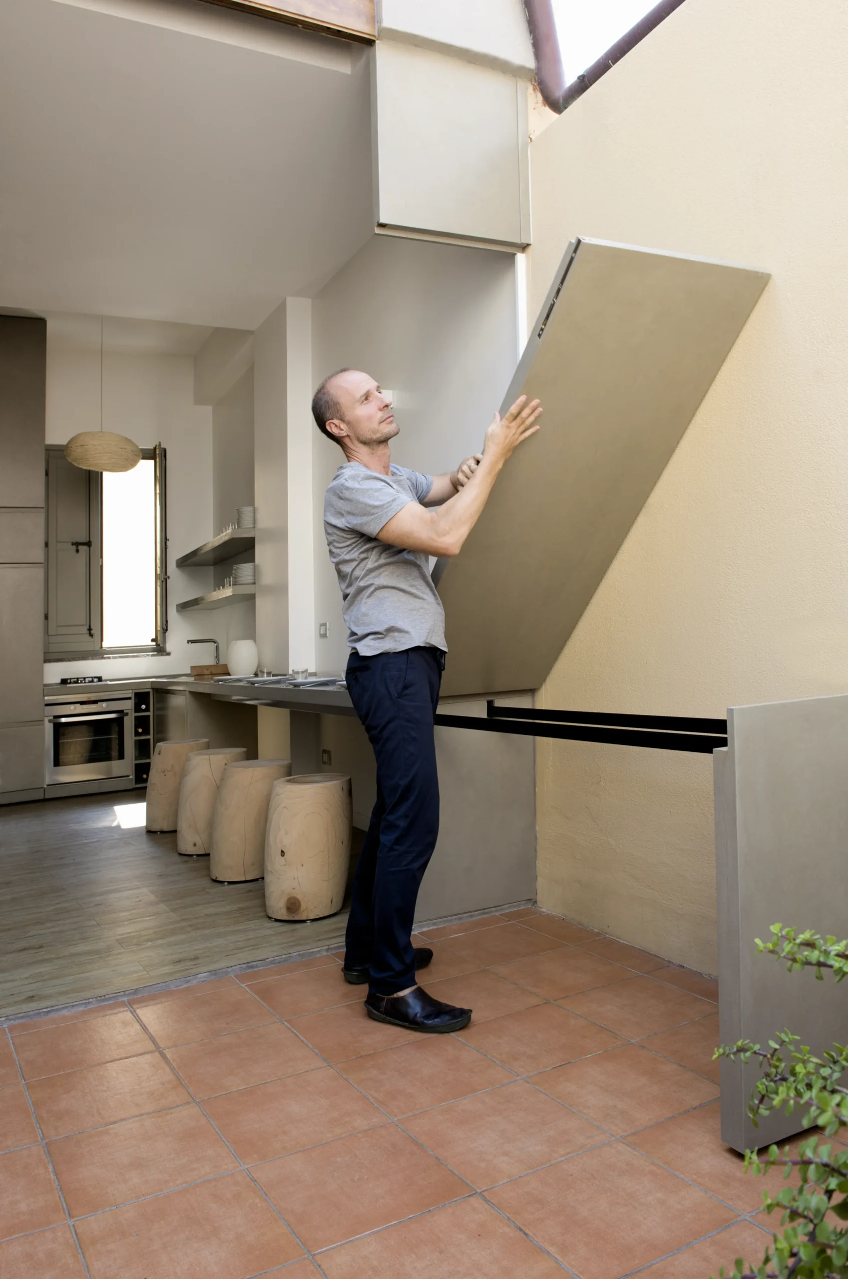 A folding panel lowered by hand to link the interior with the terrace at Space is Luxury by Studio Renato Arrigo