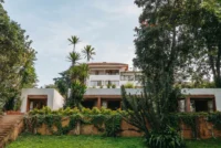 The 1976 villa of Celine and Lolo Hotel seen across its garden in Lavington, Nairobi