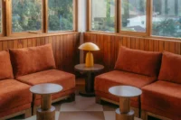 Orange banquettes and mushroom lamp in the bar at Celine and Lolo Hotel
