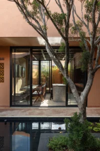 Across the courtyard water to a guest room, Da Homestay by 3fconcept
