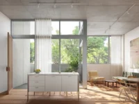 Double height duplex living space with tall windows, sheer curtains, a white kitchen island and a concrete ceiling