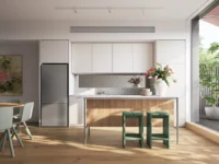 Kitchen with white cabinets, a timber island, green bar stools and a sliding door open to a planted balcony