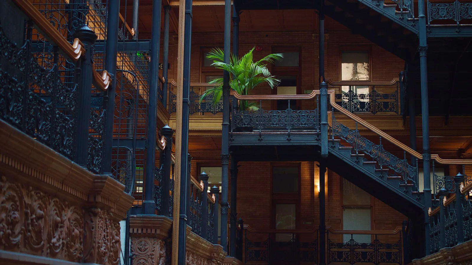 Bradbury Building atrium with cast iron staircases, open cage lifts and brick walls