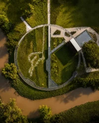 Aerial view of the ring shaped walkway, the café roof and the central path above the river bend