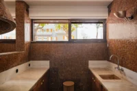 Kitchen with ochre glass tile walls and original natural stone worktops, Casa d’Abreu Neto by Álvaro Siza