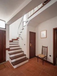 Entrance hall with the internal staircase linking the split levels, Casa d’Abreu Neto by Álvaro Siza