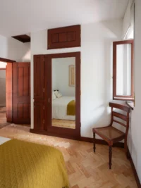 Bedroom with original built in furniture and a window onto the garden, Casa d’Abreu Neto by Álvaro Siza