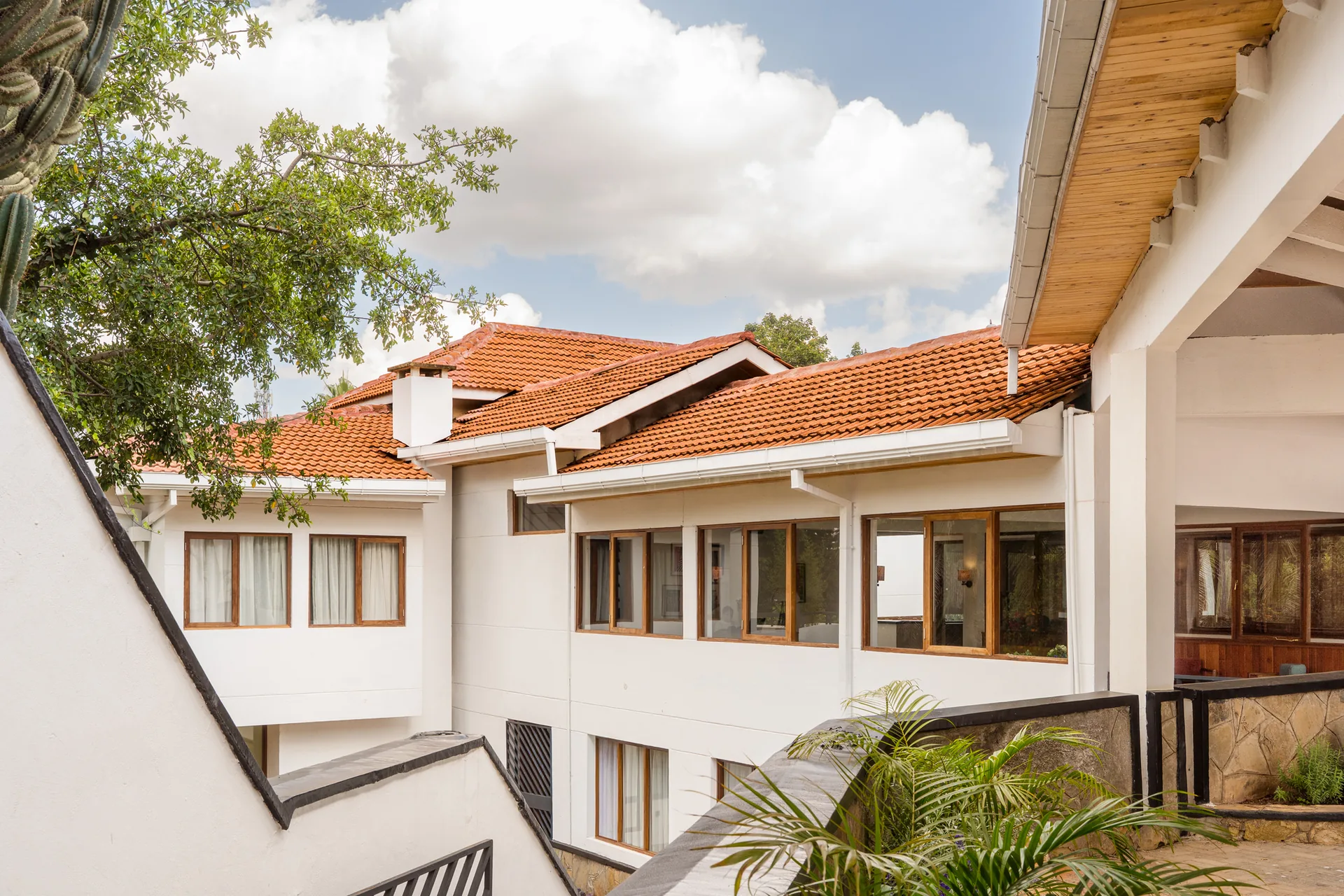 Tiled sloped roofs of the 1990s additions at Celine and Lolo Hotel by Powerhouse Company