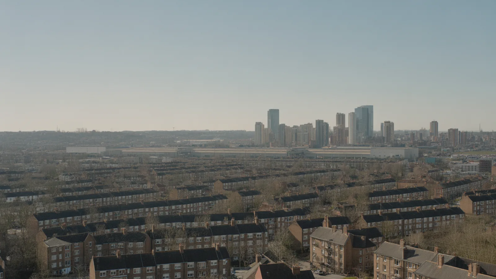 Aerial transect from a high-rise downtown through warehouses and terraced housing to detached suburbs