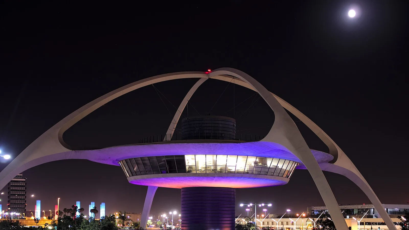 LAX Theme Building parabolic arches lit at night at Los Angeles International Airport