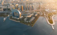 Aerial view of Crescent Bay with the low-rise residential buildings among gardens on the waterfront below the city skyline