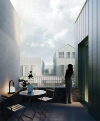 Evening terrace with a table and lamp overlooking pitched roof houses in pale cladding