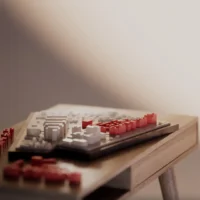Close view of a site model on a wooden table with the new buildings picked out in red