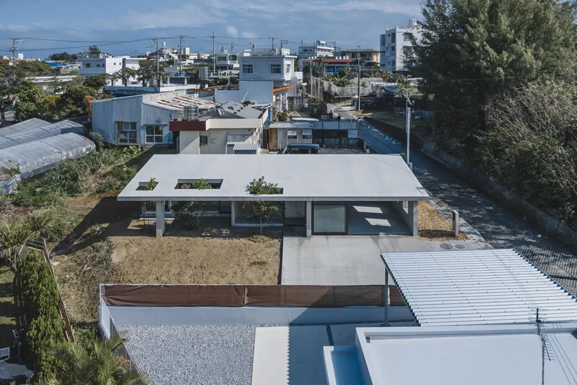 Interior of the Okinawa house with overlapping concrete walls and columns under a wide roof