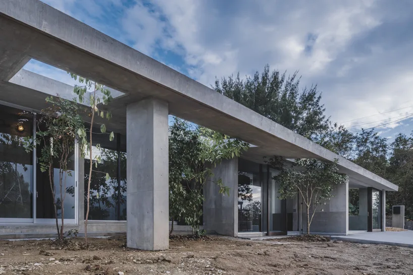 Sheltered space between concrete columns opening to the garden at the Okinawa house