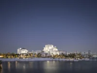 Natural History Museum Abu Dhabi by Mecanoo seen across the water at dusk