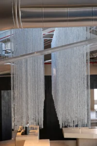 Suspended metal chains in the double height at Origin Cafe and Roasters Jax