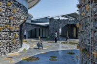Visitors and planting beds in the courtyard of Future Life Village Pavilion