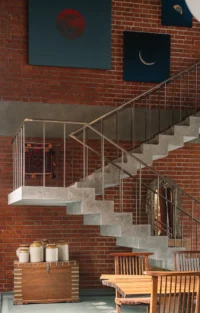 Salvaged treads set in concrete on the staircase, The House of Memories