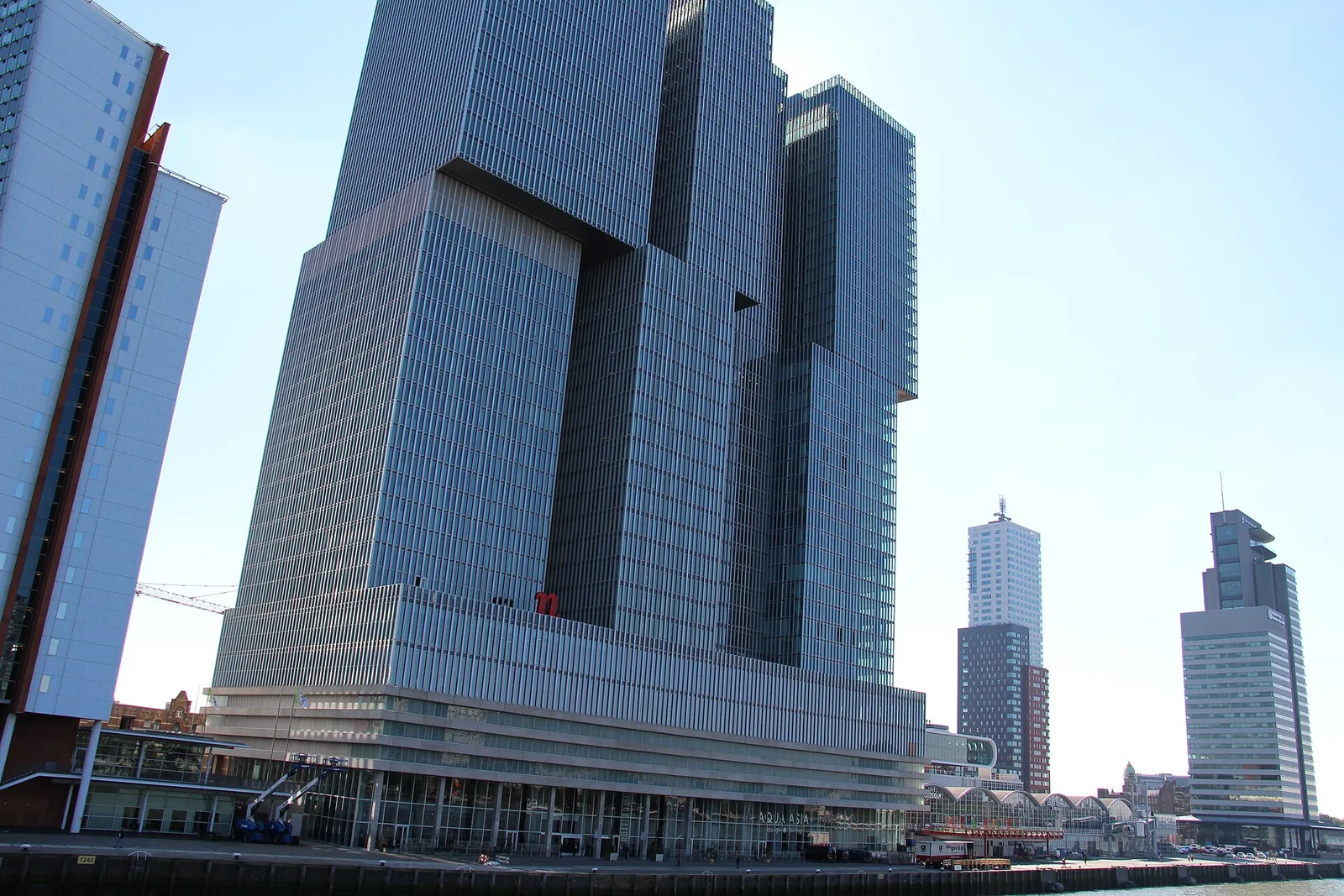 De Rotterdam by OMA, a cluster of stacked glass towers on the Rotterdam waterfront under a clear sky