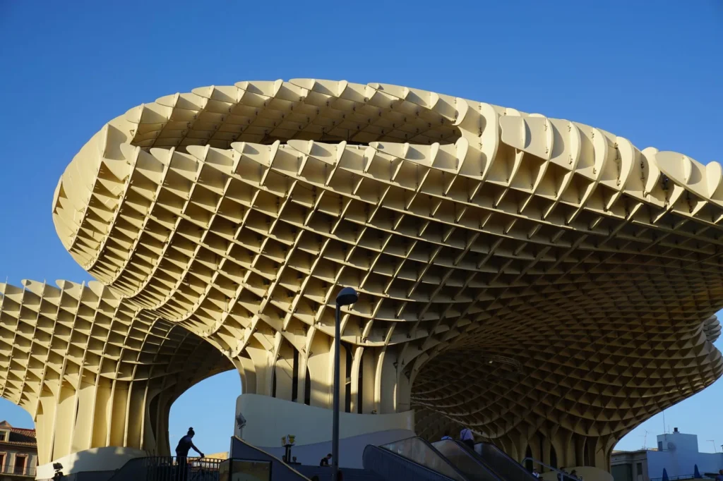 Waffle-grid timber canopy of the Metropol Parasol in Seville against a blue sky