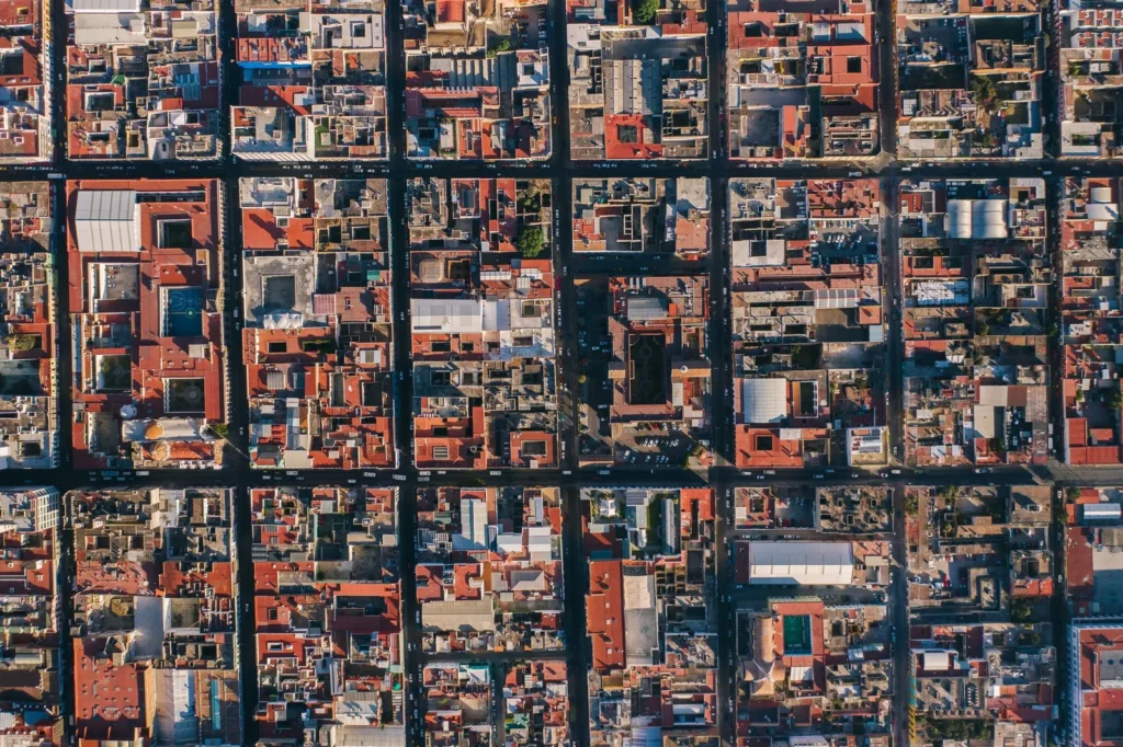 Aerial view of a dense city grid of blocks with inner courtyards, the kind of context artificial intelligence architecture tools analyze