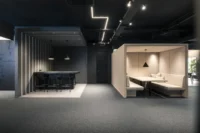 Bar counter in a striped niche beside a cream timber booth with bench seating, ADDITIVE HQ by NOA