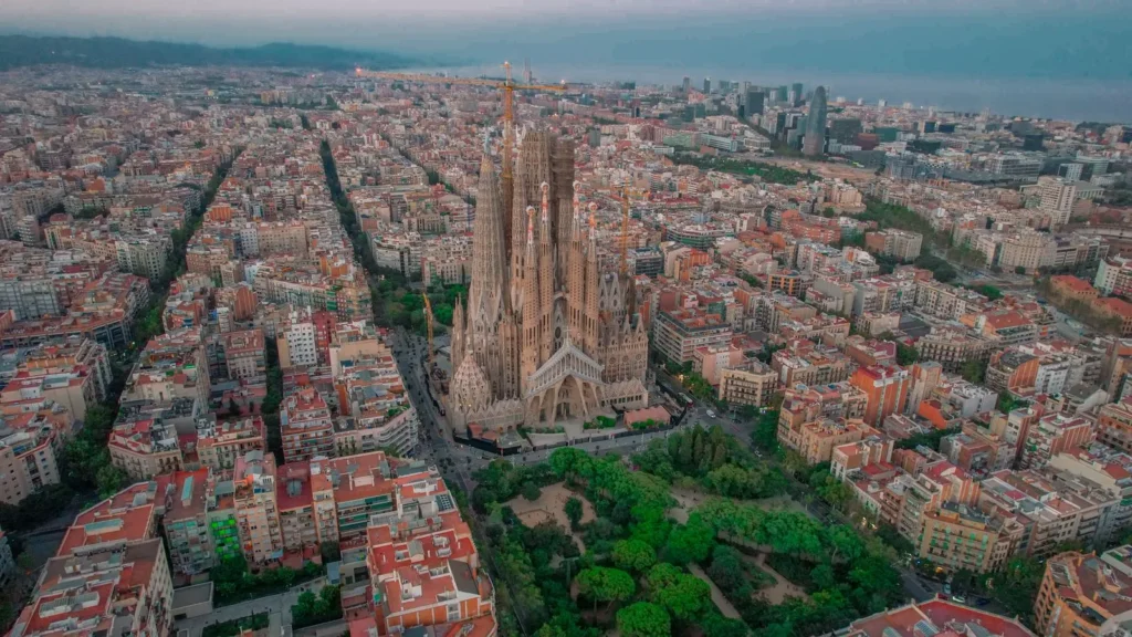 Aerial view of the Eixample district in Barcelona, its regular city blocks laid out around the Sagrada Família