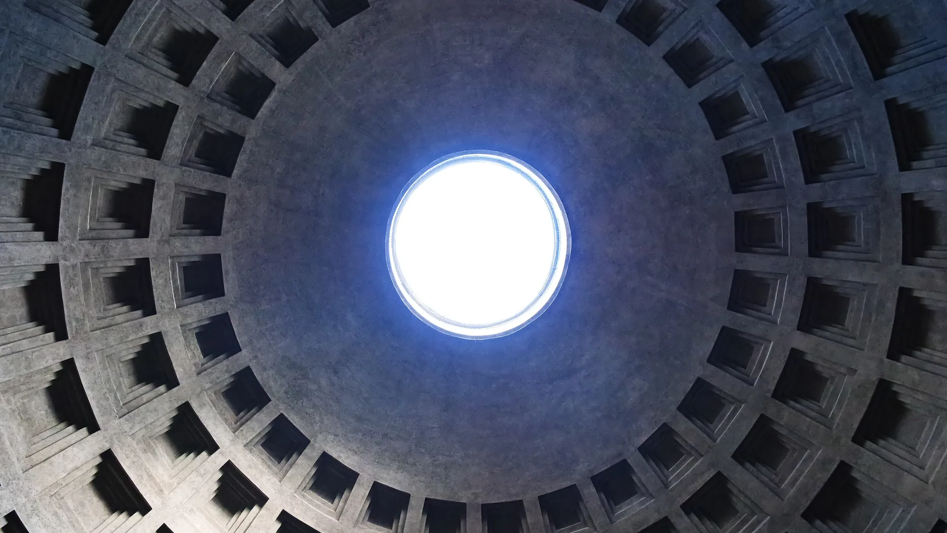 Coffered concrete dome of the Pantheon in Rome seen from below, with the round oculus at its centre