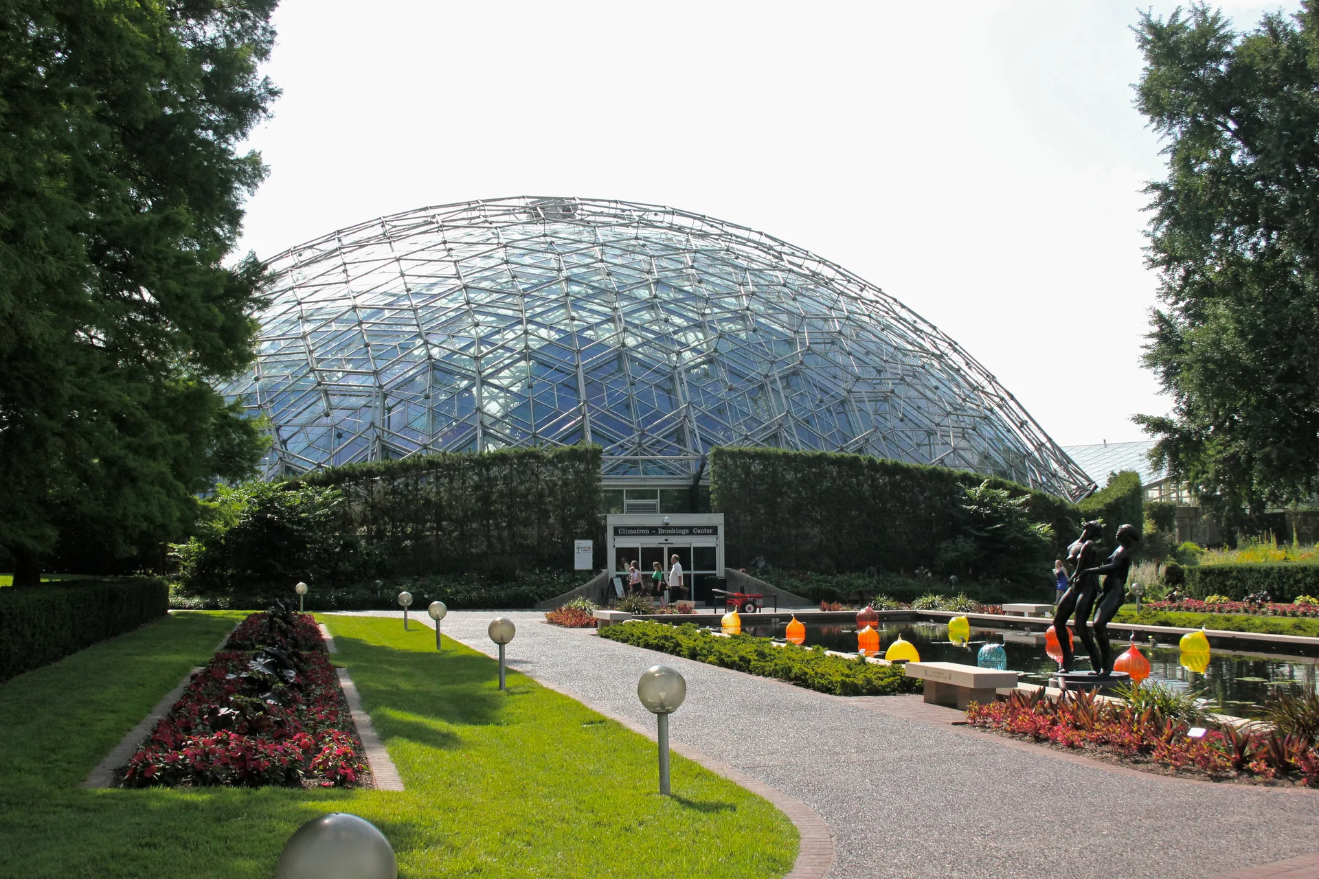 Climatron geodesic glass dome at the Missouri Botanical Garden in St. Louis, seen across a formal garden path
