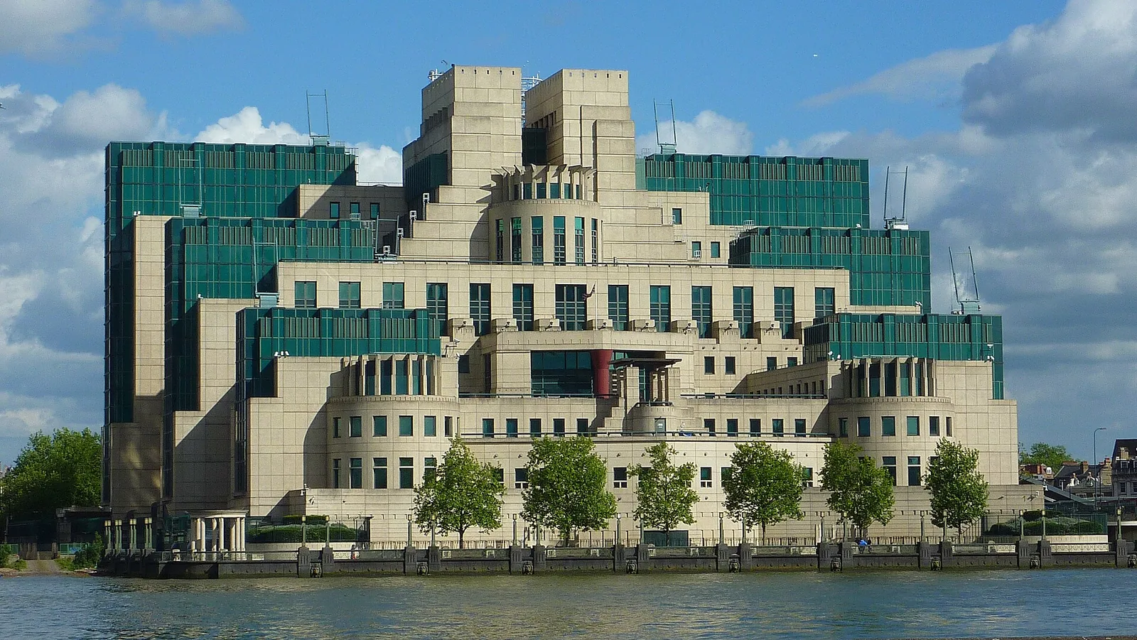 Stepped stone and green glass facade of the SIS Building at Vauxhall Cross seen across the River Thames