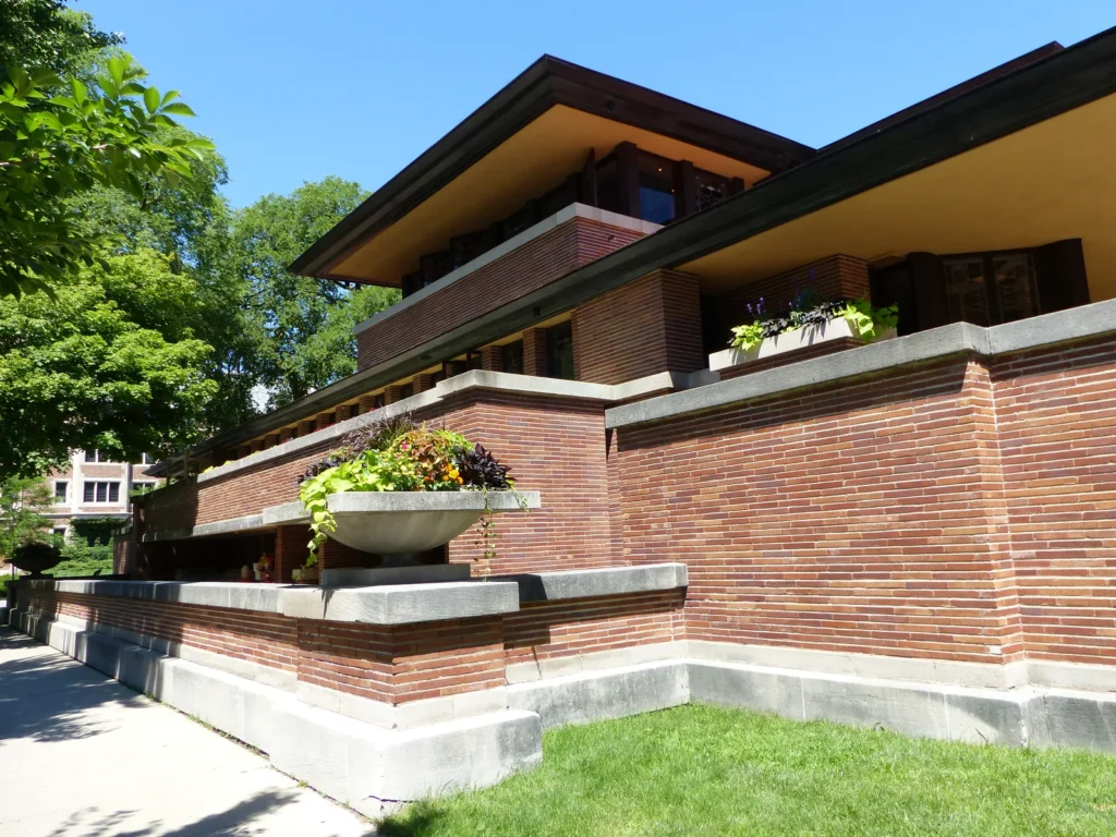 Long brick walls and deep cantilevered roofs of the Robie House in Chicago, a Prairie style landmark