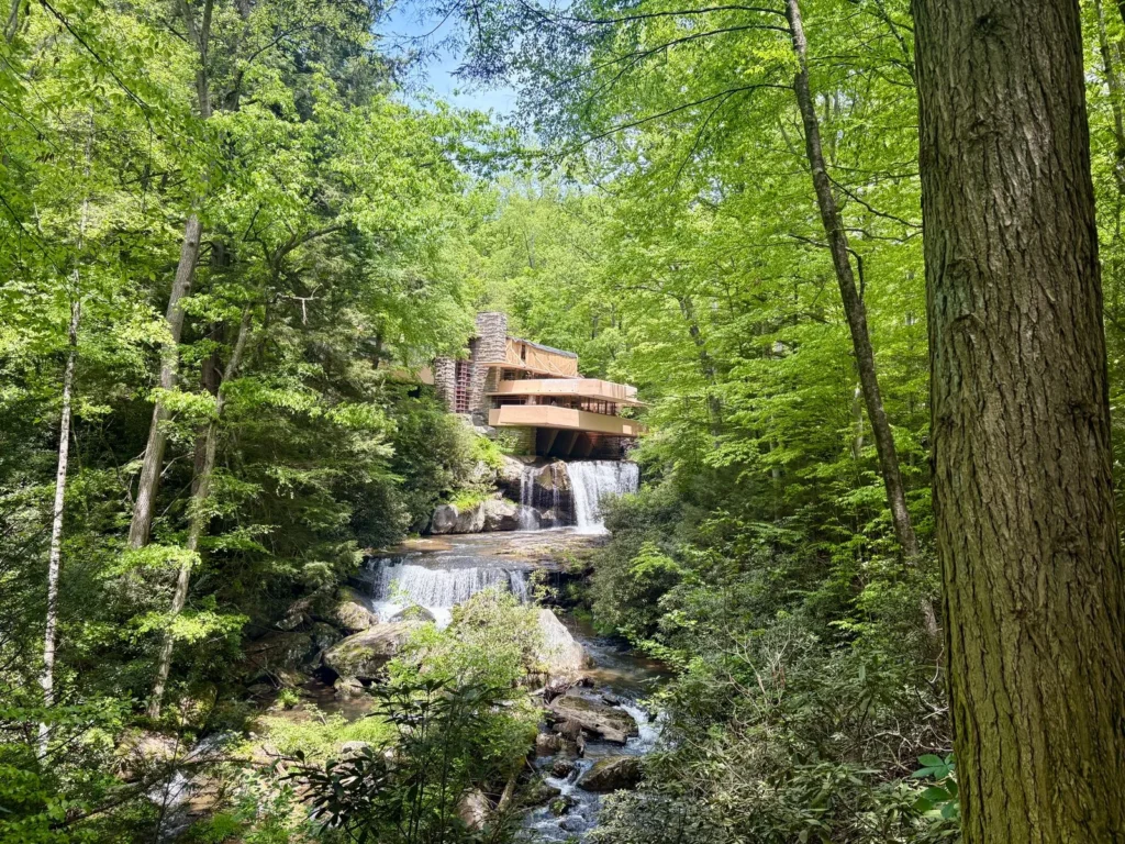 Fallingwater in Pennsylvania, its concrete terraces stretching over the stream among green trees, a high point of Frank Lloyd Wright architecture