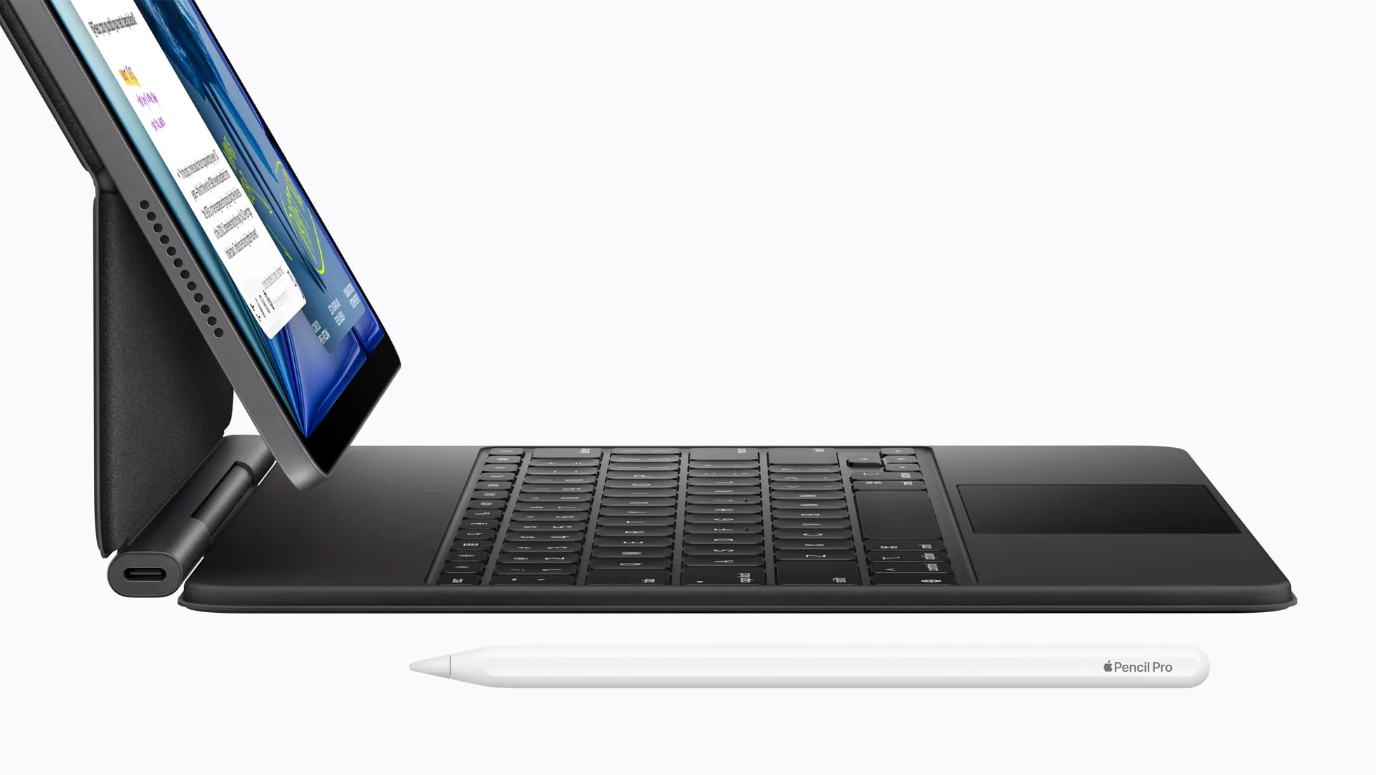 iPad Air propped on a Magic Keyboard with an Apple Pencil Pro lying in front, side view