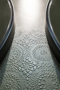 Close view of green resin surface with a pressed South Tyrolean lace relief, Lake House Völs by NOA