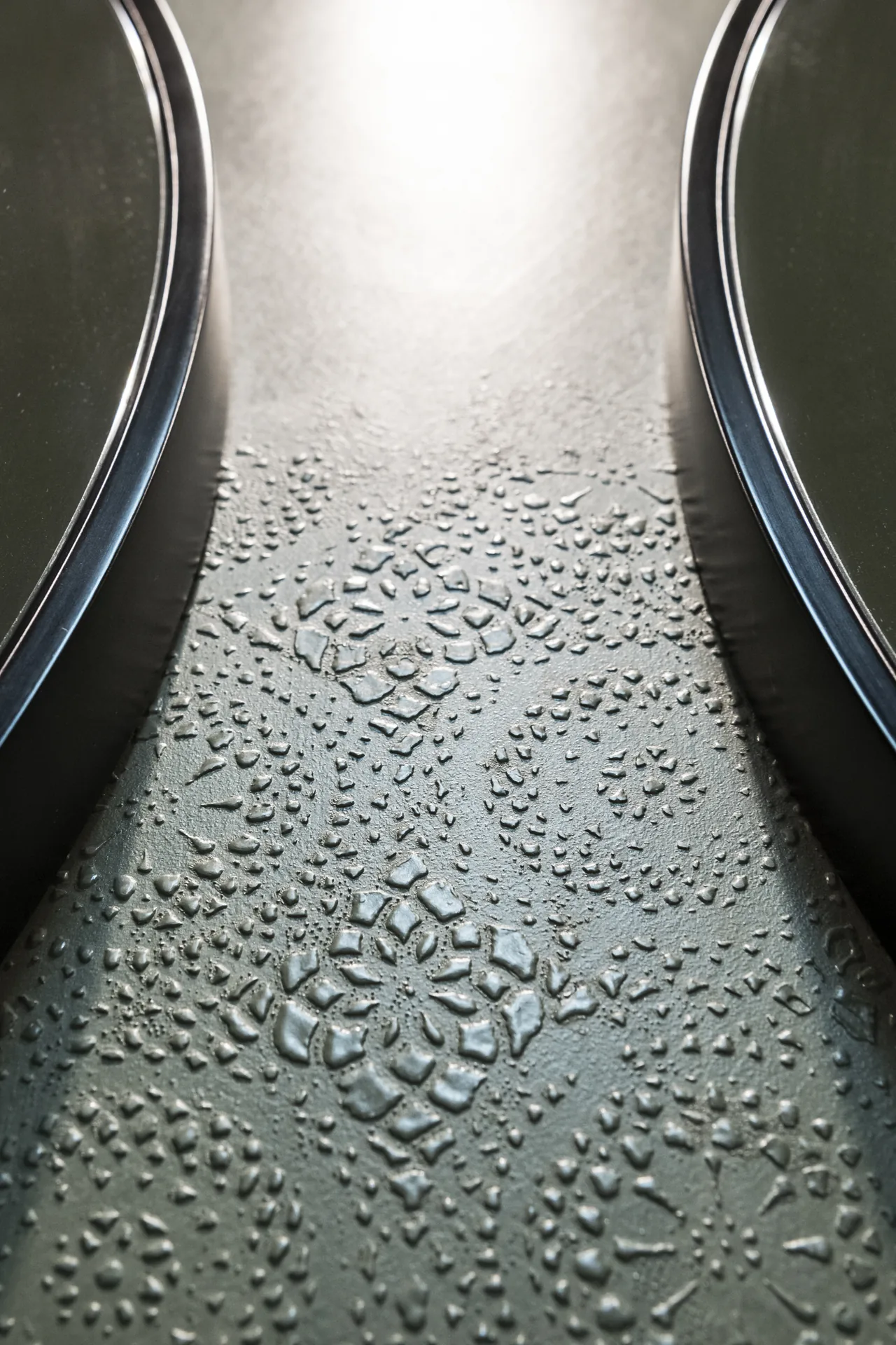 Close view of green resin surface with a pressed South Tyrolean lace relief, Lake House Völs by NOA