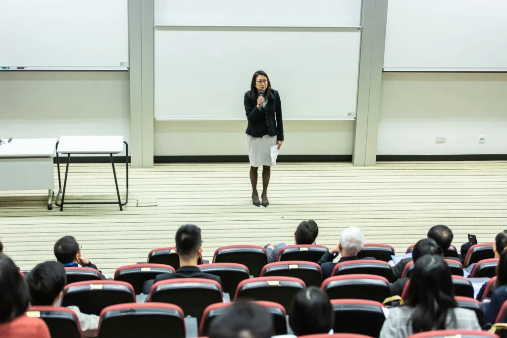 Speaker addressing a full lecture theatre, the format behind masters of architecture TED talks