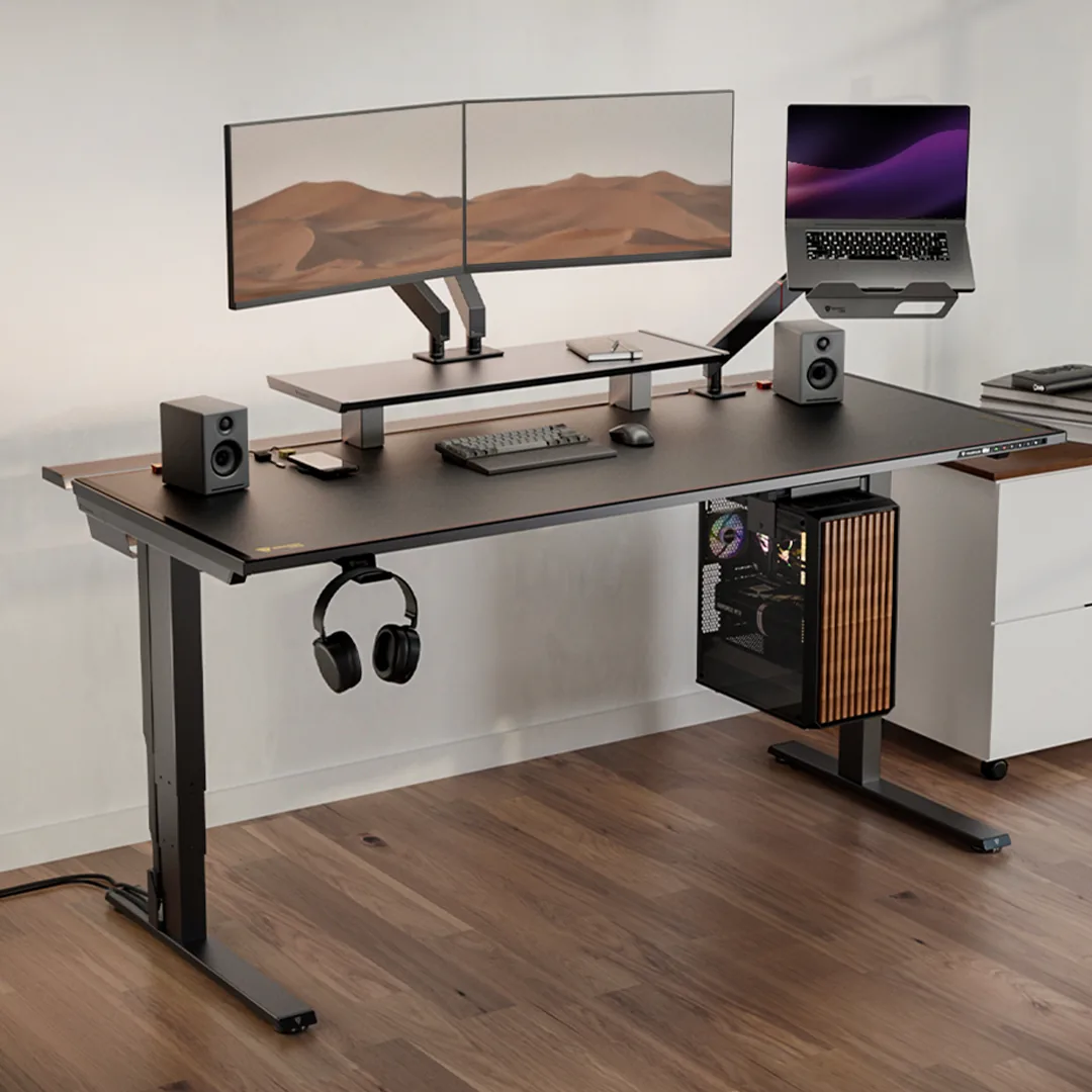 Secretlab MAGNUS Pro desk in black with a dual monitor arm, laptop stand and under-desk PC mount