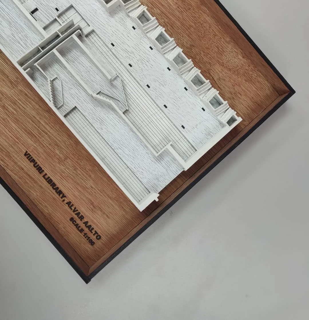 Detailed white physical model of Alvar Aalto's Viipuri Library on a wooden base with finely printed roof texture