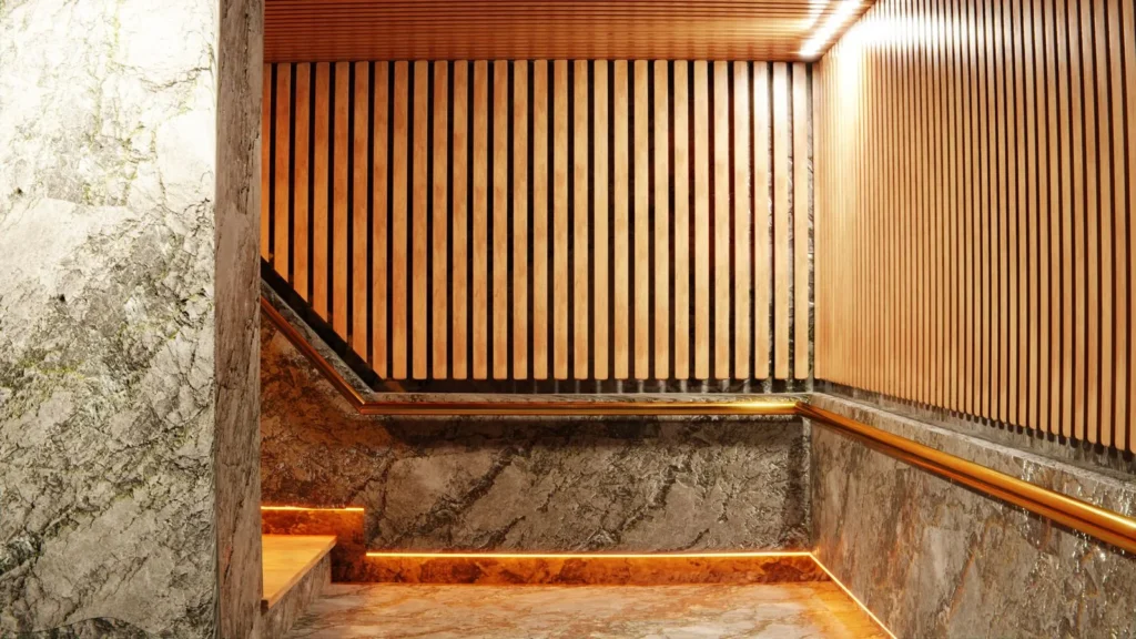 Staircase wrapped in veined marble and warm vertical wood slats lit by a hidden LED strip
