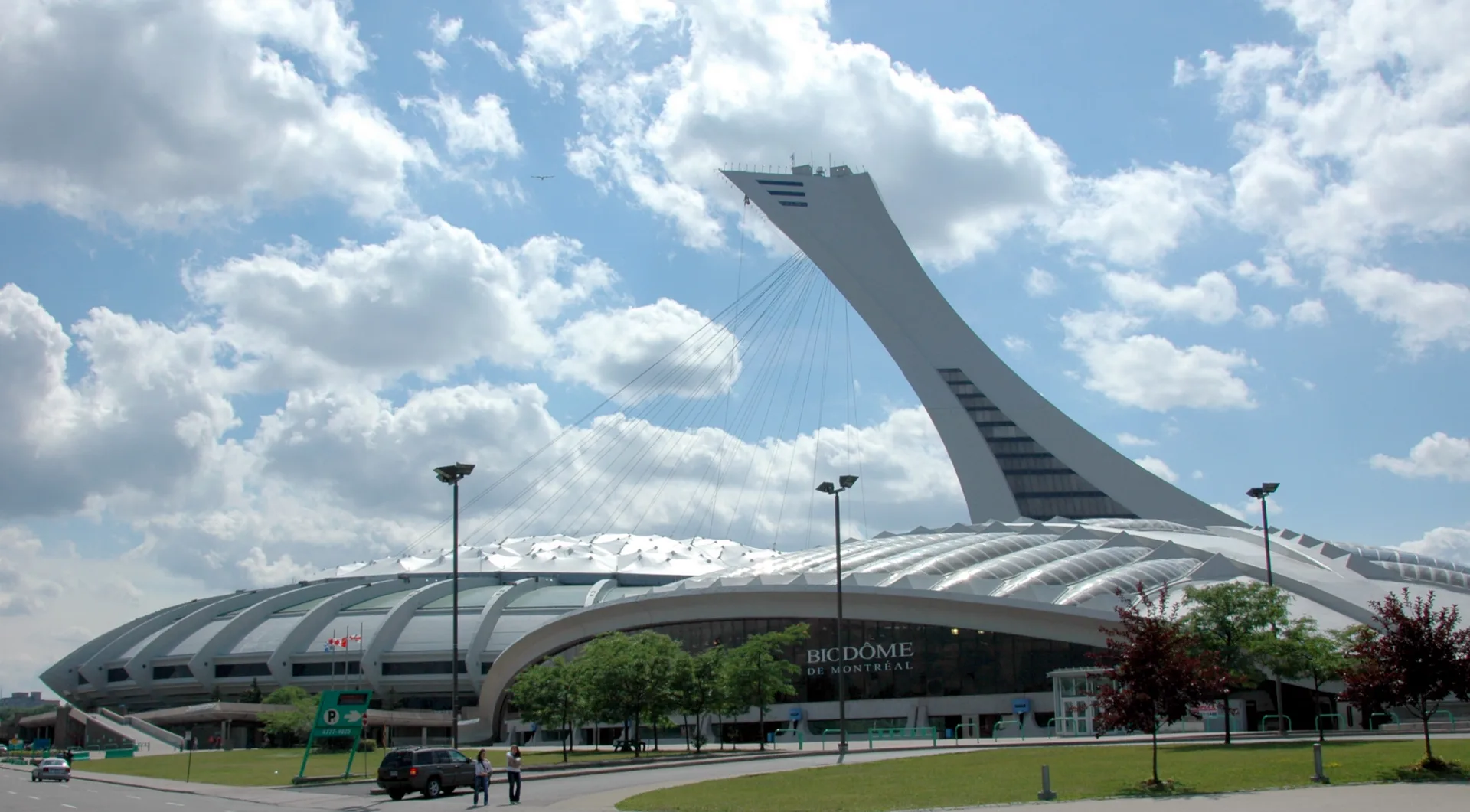 Biodome de Montreal entrance under the ribbed roof of the former Olympic velodrome, inclined stadium tower behind
