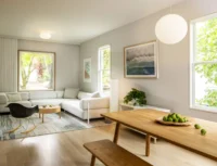 Open main floor with an oak dining table and bench in front of a white sectional sofa and a paper globe pendant, Phinney Mini by Best Practice Architecture