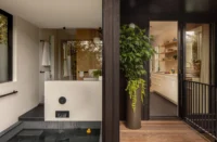 Bathroom with a sunken soaking tub beside the kitchen door, both opening onto the rear deck, Phinney Mini by Best Practice Architecture