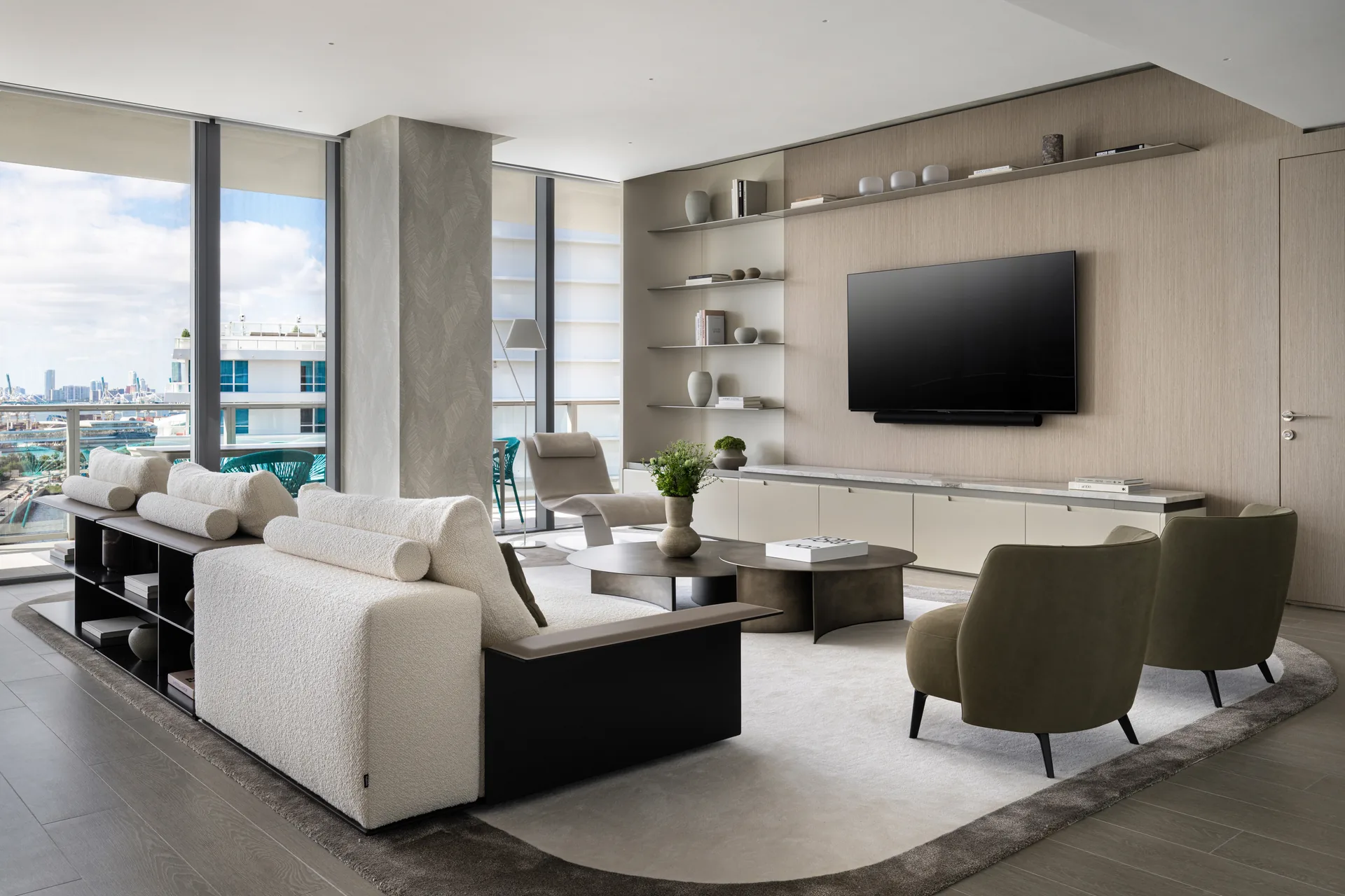 Living area with a cream sofa, low leather shelves and a light wood TV wall with floating metal shelves, PS Apartment by Nar Design Studio