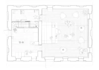 Ground floor plan with the bar and seating in the larger room and service spaces and stair in the smaller one