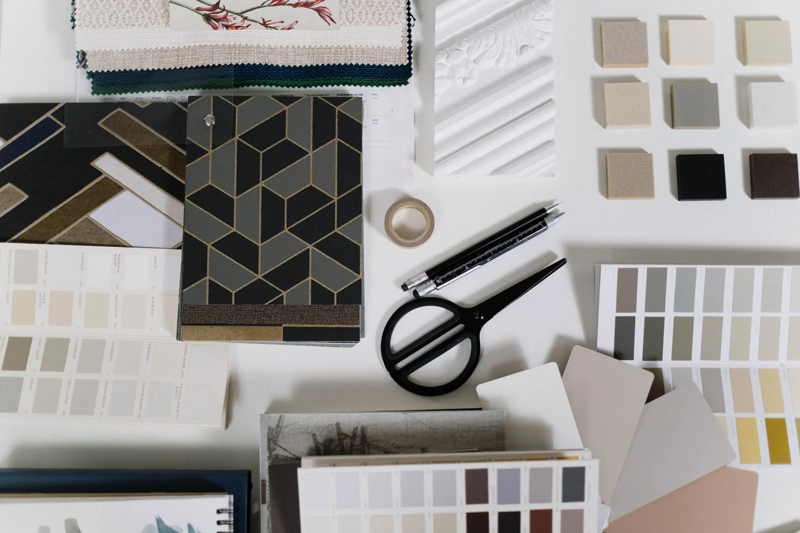 Flat lay of interior material samples, fabric swatches and colour chips used as design references