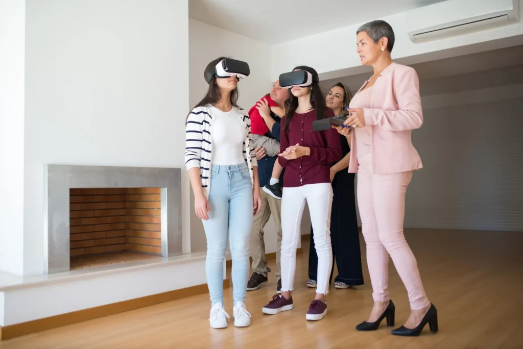 Family wearing VR headsets on a guided walkthrough of an empty living room, showing one of the key technologies in interior design