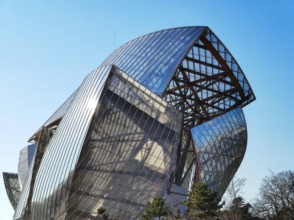 Curved glass sails supported by steel and timber framing at the Fondation Louis Vuitton in Paris